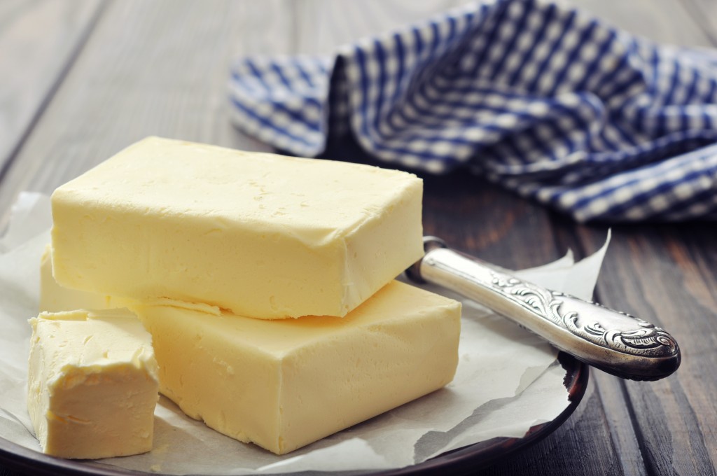 Fresh butter on wooden cutting board with knife closeup premier meat company perfect thanksgiving turkey meat delivery free range