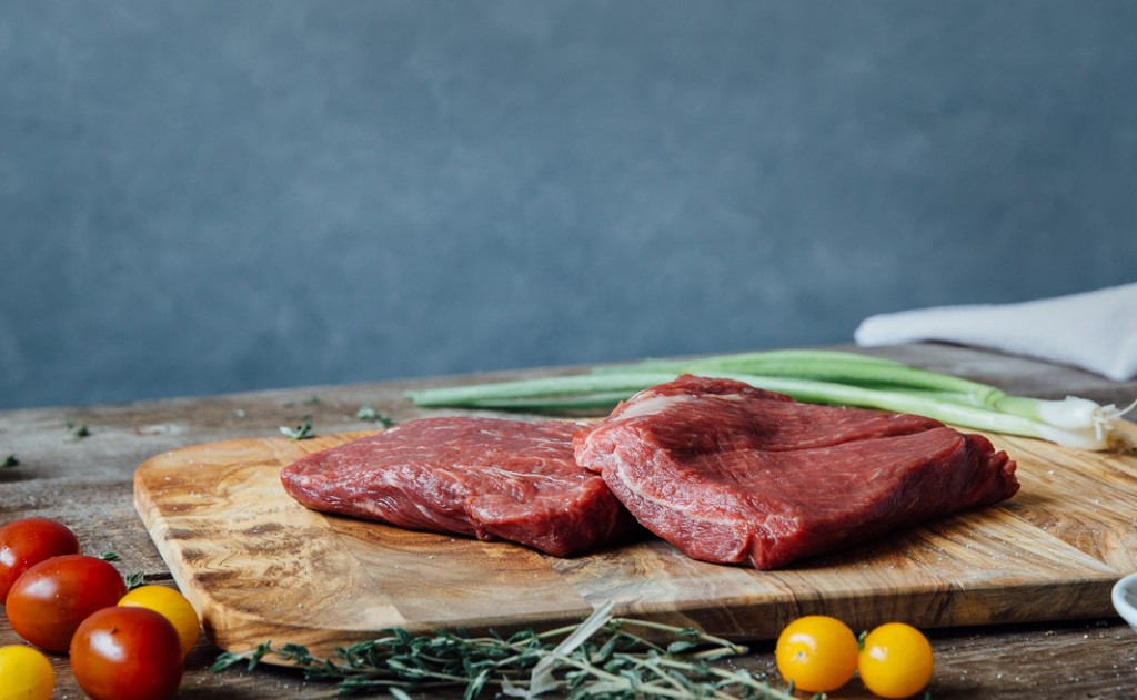 premier meat company wet aged flat iron beef steak raw tomatoes high quality proteins delivery fresh meat